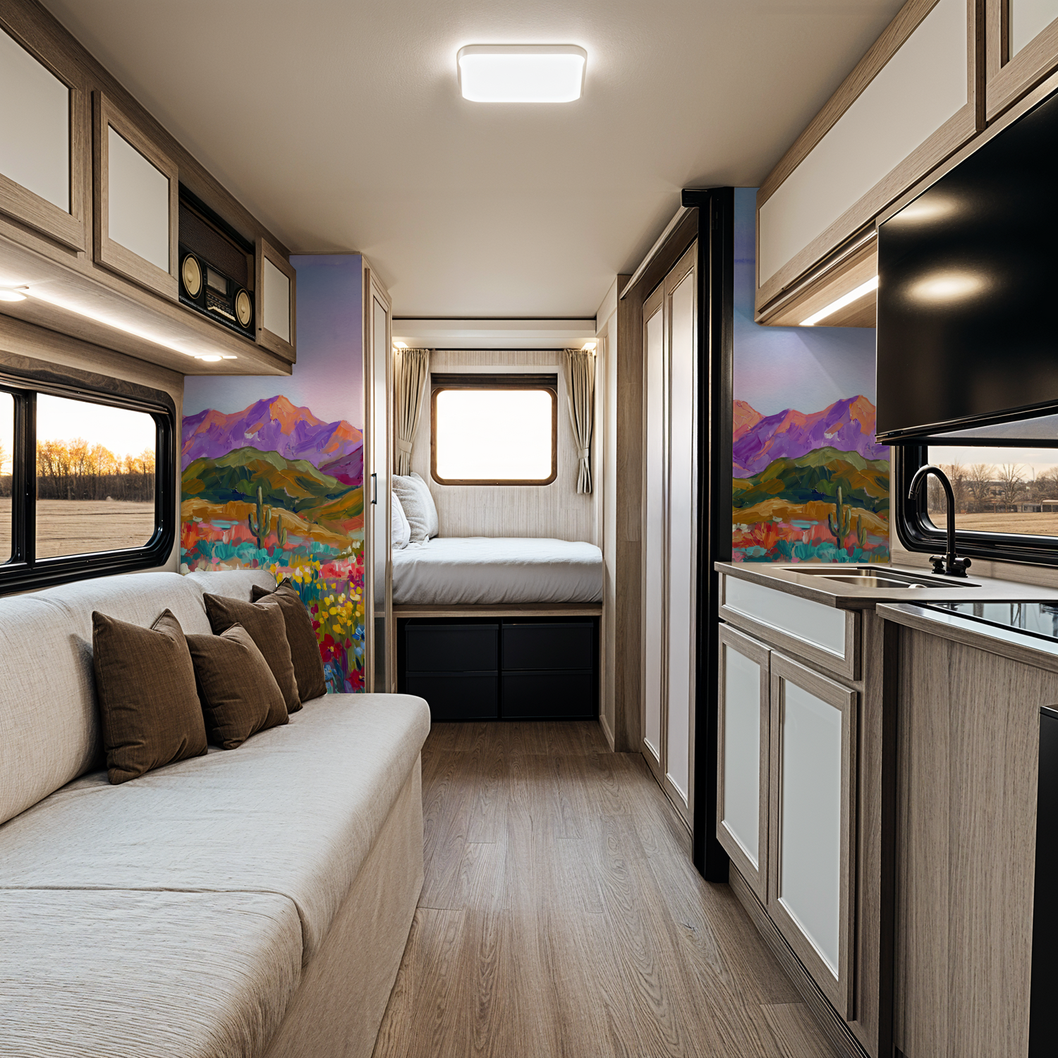 Colorful desert landscape wallpaper with mountains and cacti in RV interior.