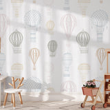 Ellie Wallpaper by Wall Blush SG02 in a stylish, sunlit children's room, featuring playful hot air balloon designs.
