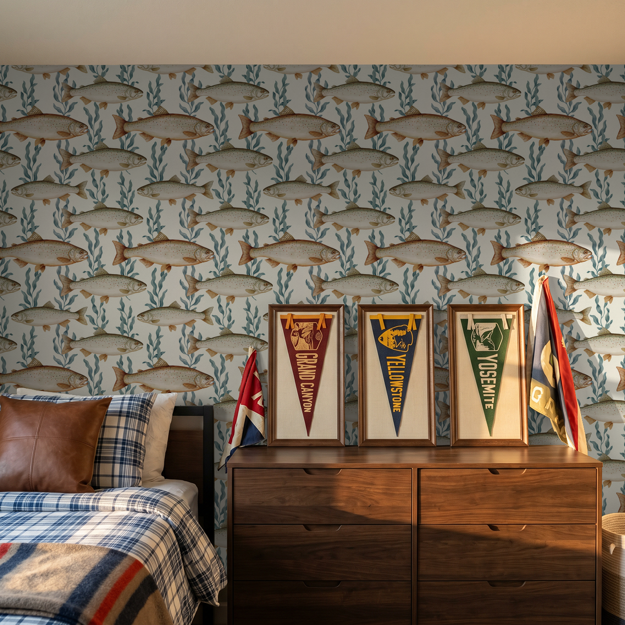 Fish and seaweed wallpaper in rustic bedroom with wooden dresser and flags.
