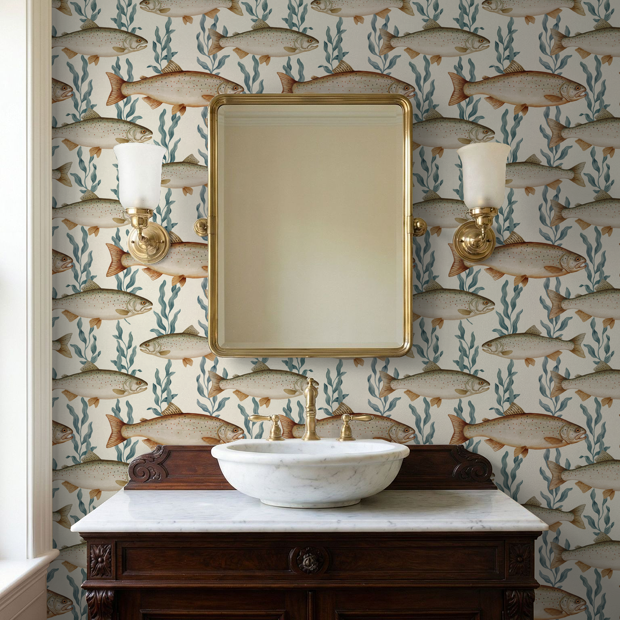 Fish and seaweed wallpaper in a vintage bathroom with a marble sink and gold mirror.