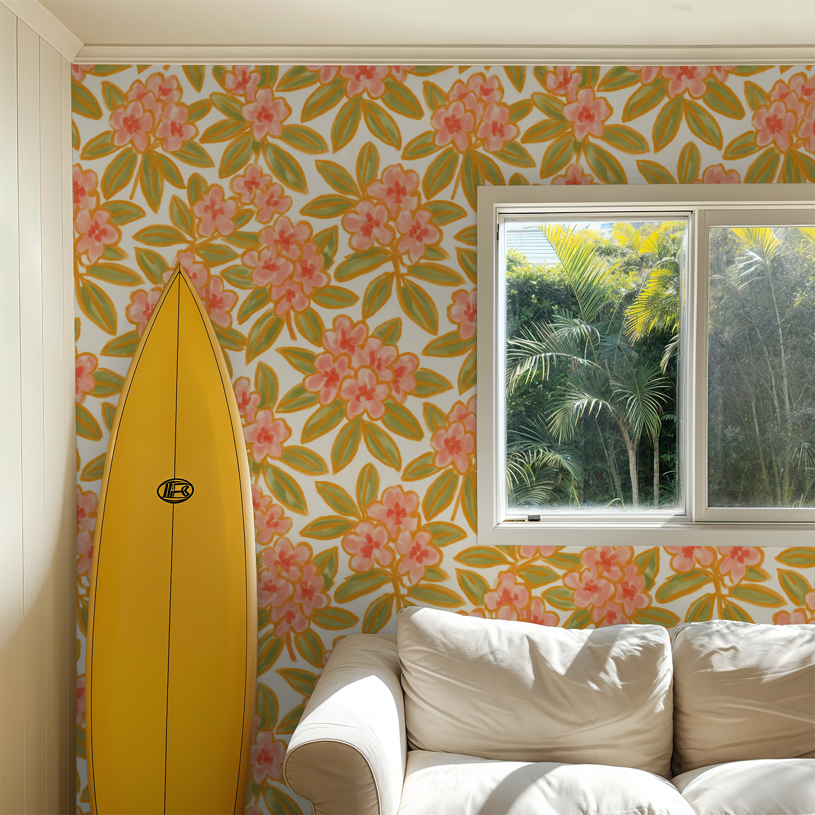 Floral wallpaper with pink flowers and green leaves in a sunny living room with a surfboard.