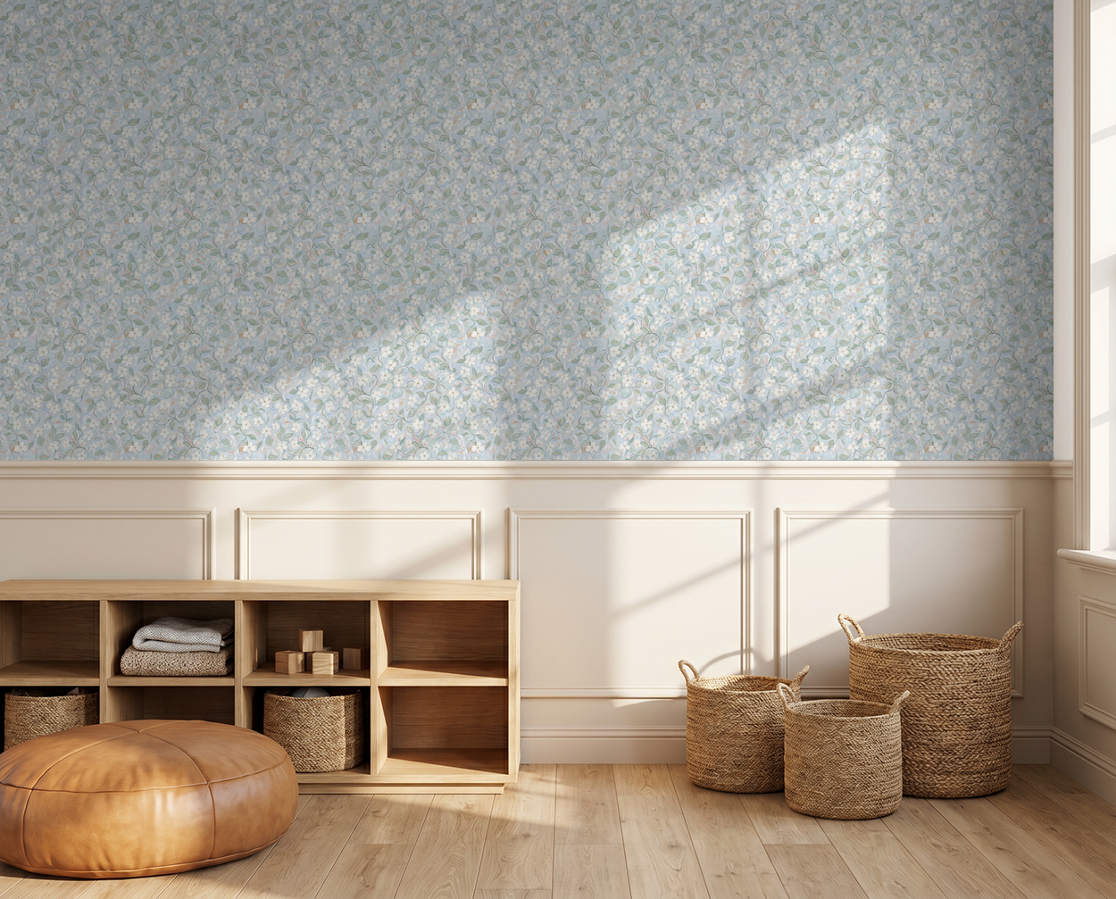 Floral wallpaper with soft blues and greens in a sunlit room with wicker baskets and wooden furniture.
