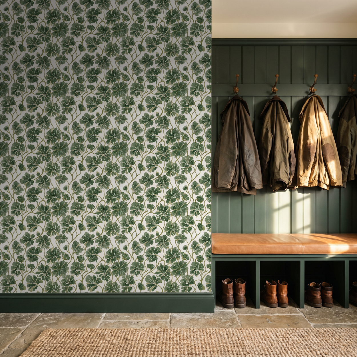Gilded Grove green foliage wallpaper in a mudroom with coats and boots.