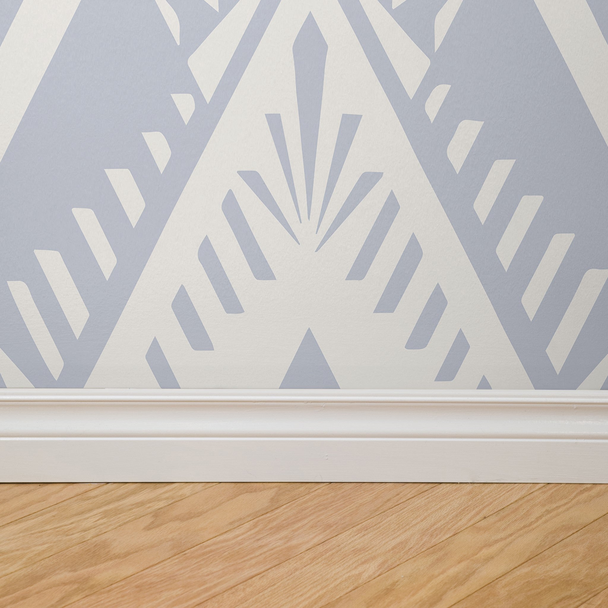 "Gloria Wallpaper by Wall Blush in a modern room, geometric pattern focus with beige wooden floor."