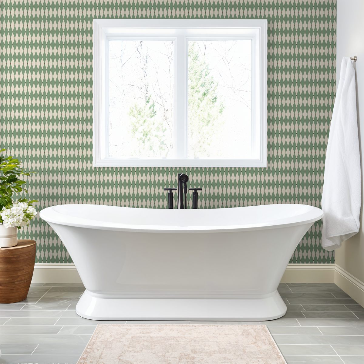 Green and cream diamond pattern wallpaper in a modern bathroom with a white bathtub.