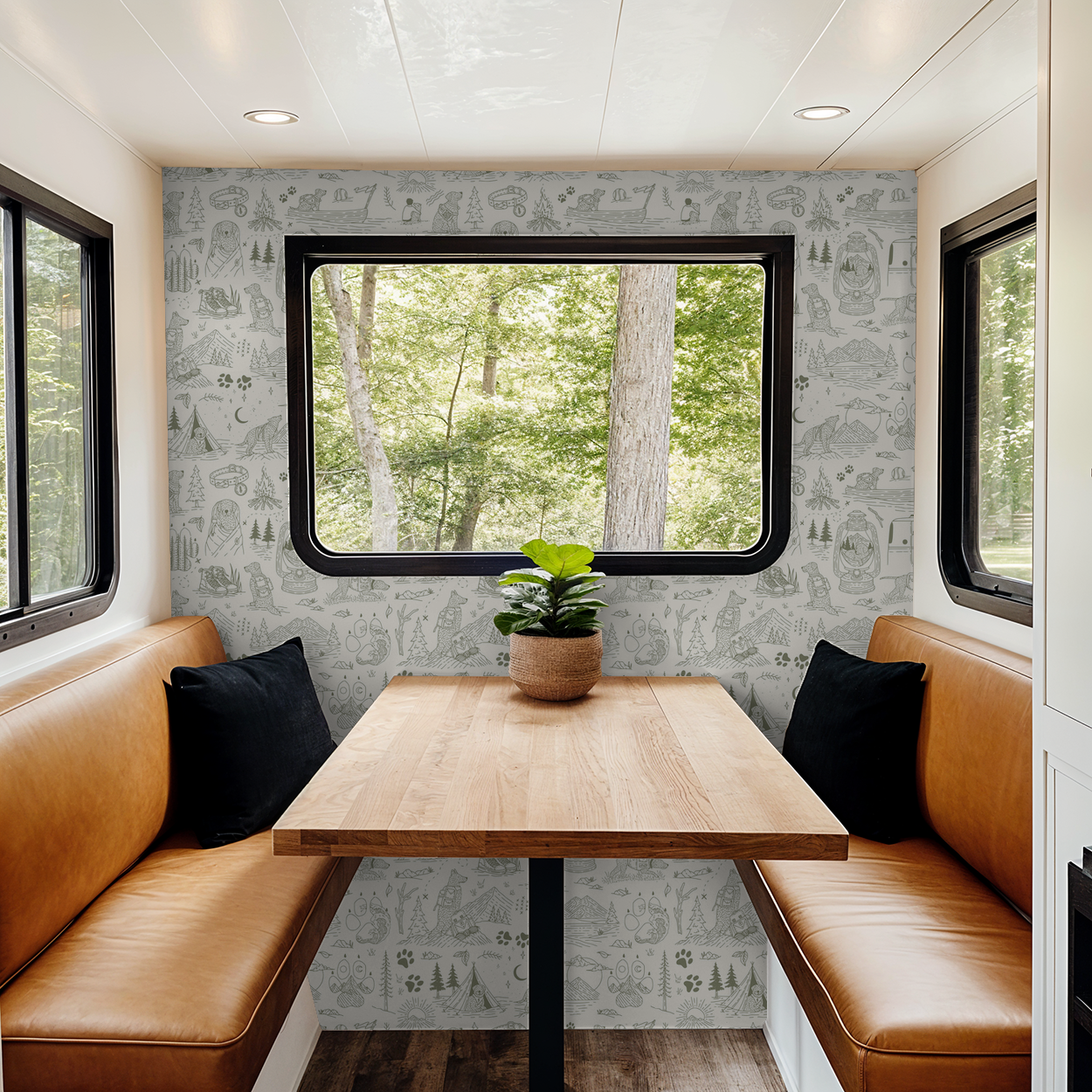 Green and cream whimsical dog and nature wallpaper in cozy dining nook with leather seating.