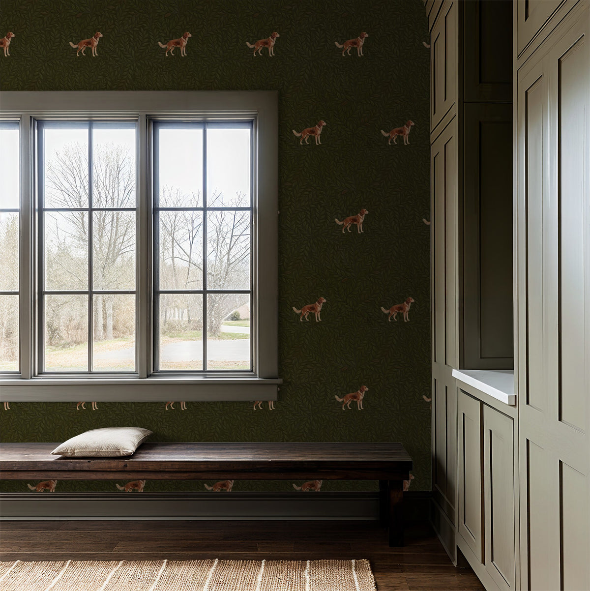 Green wallpaper with foliage and dog pattern in cozy entryway with bench.