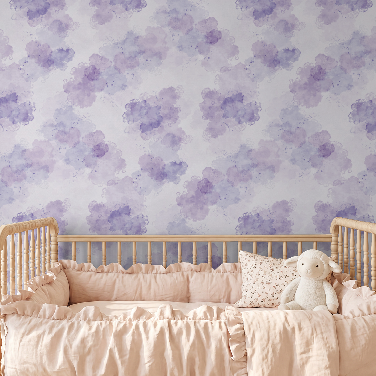Lavender watercolor cloud wallpaper in a serene nursery with wooden crib.