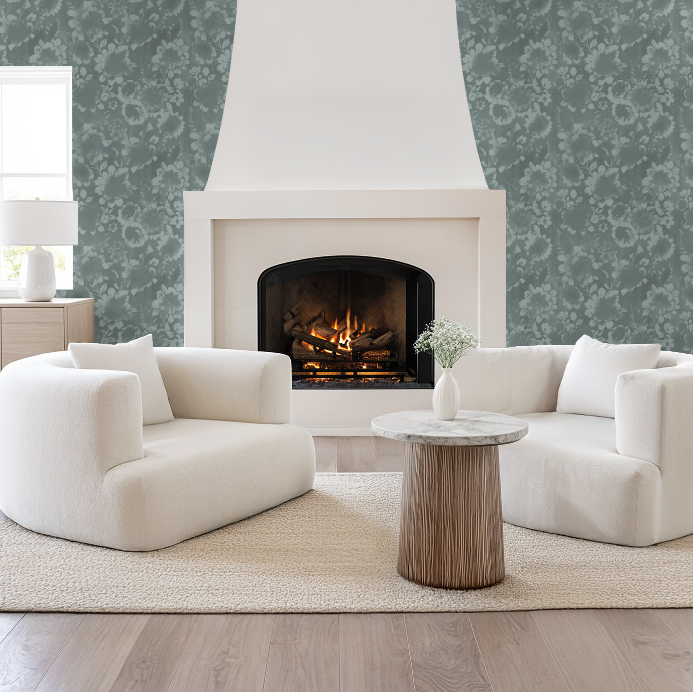 Light teal floral wallpaper in modern living room with fireplace and white sofas.
