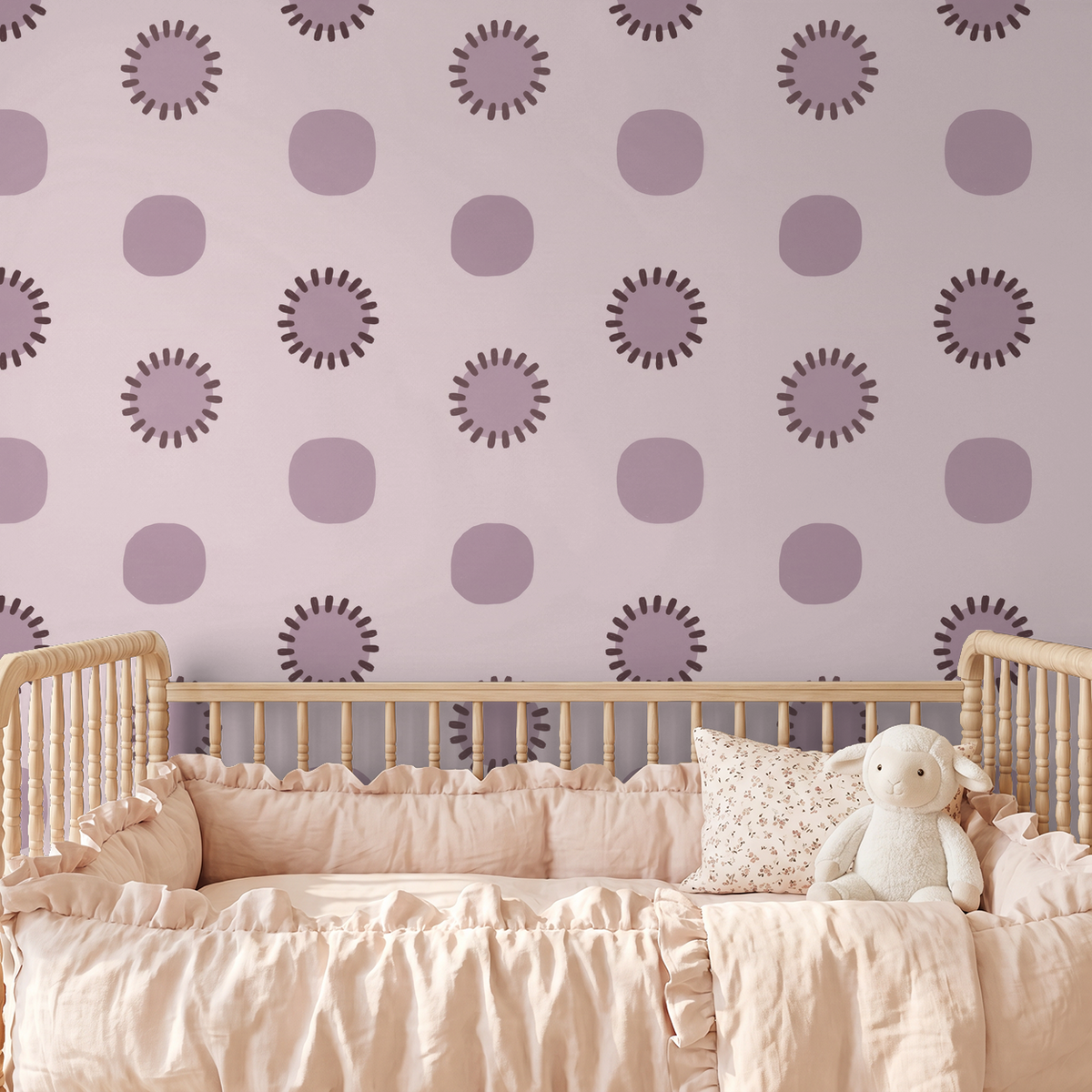 Mauve circle wallpaper in nursery with wooden crib and plush toy