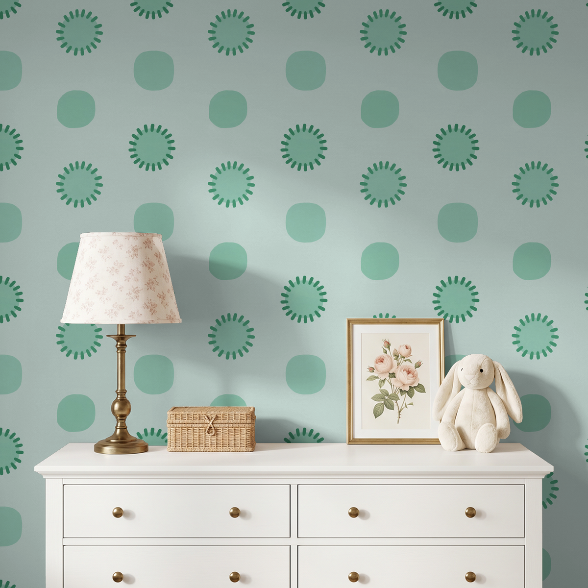 Mint circular geometric wallpaper in a nursery with white dresser and decor.