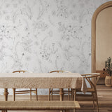 "Lined Meadow Wallpaper by Wall Blush in a cozy dining room, highlighting elegant floral patterns."