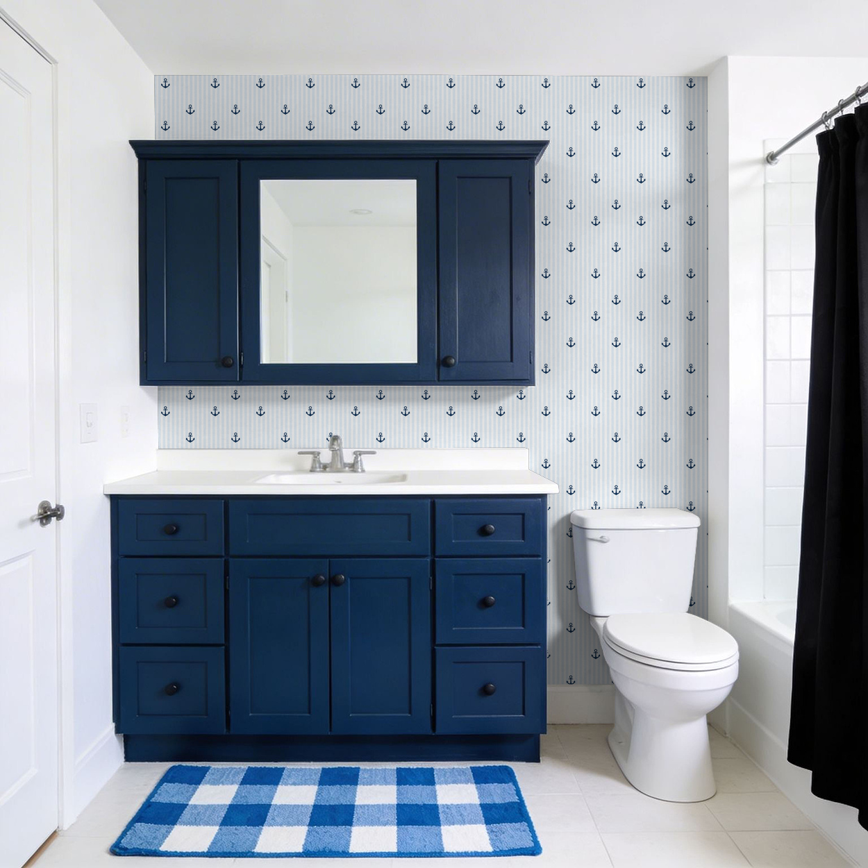 Nautical blue anchor wallpaper in a modern bathroom with navy cabinets.