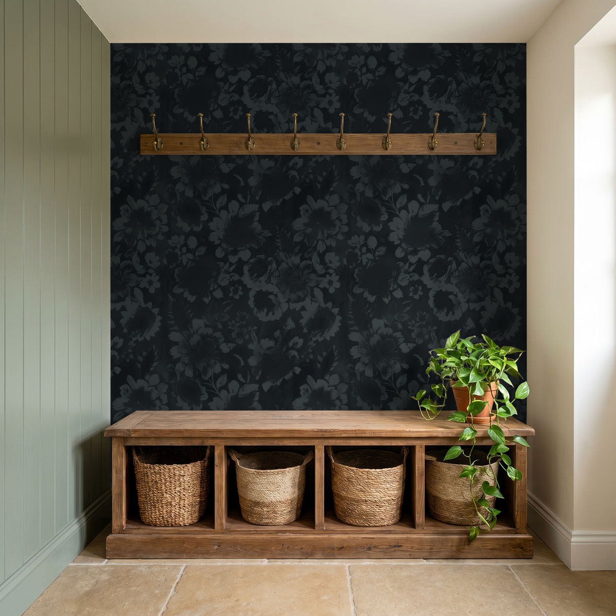 Navy floral wallpaper with shadowy blooms in a cozy entryway with wooden bench and plants.