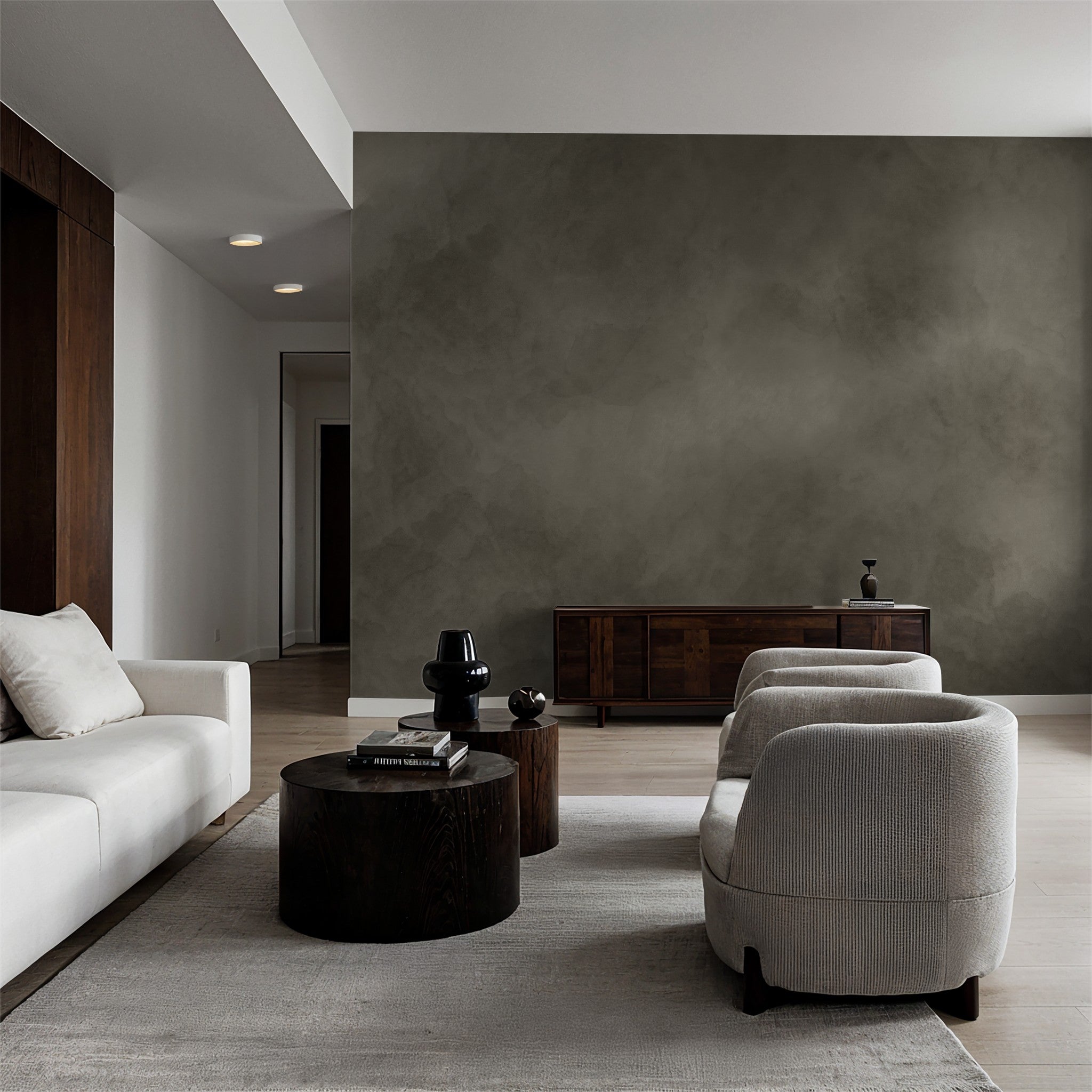 Olive abstract textured wallpaper in modern living room with dark wood and cream furniture.