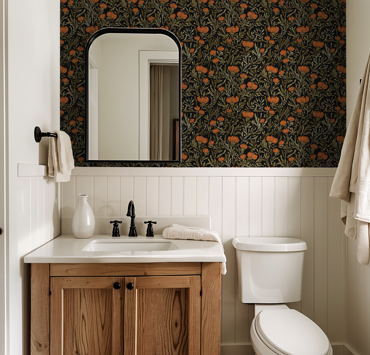 Bathroom with bold orange floral wallpaper on black background above wood vanity.