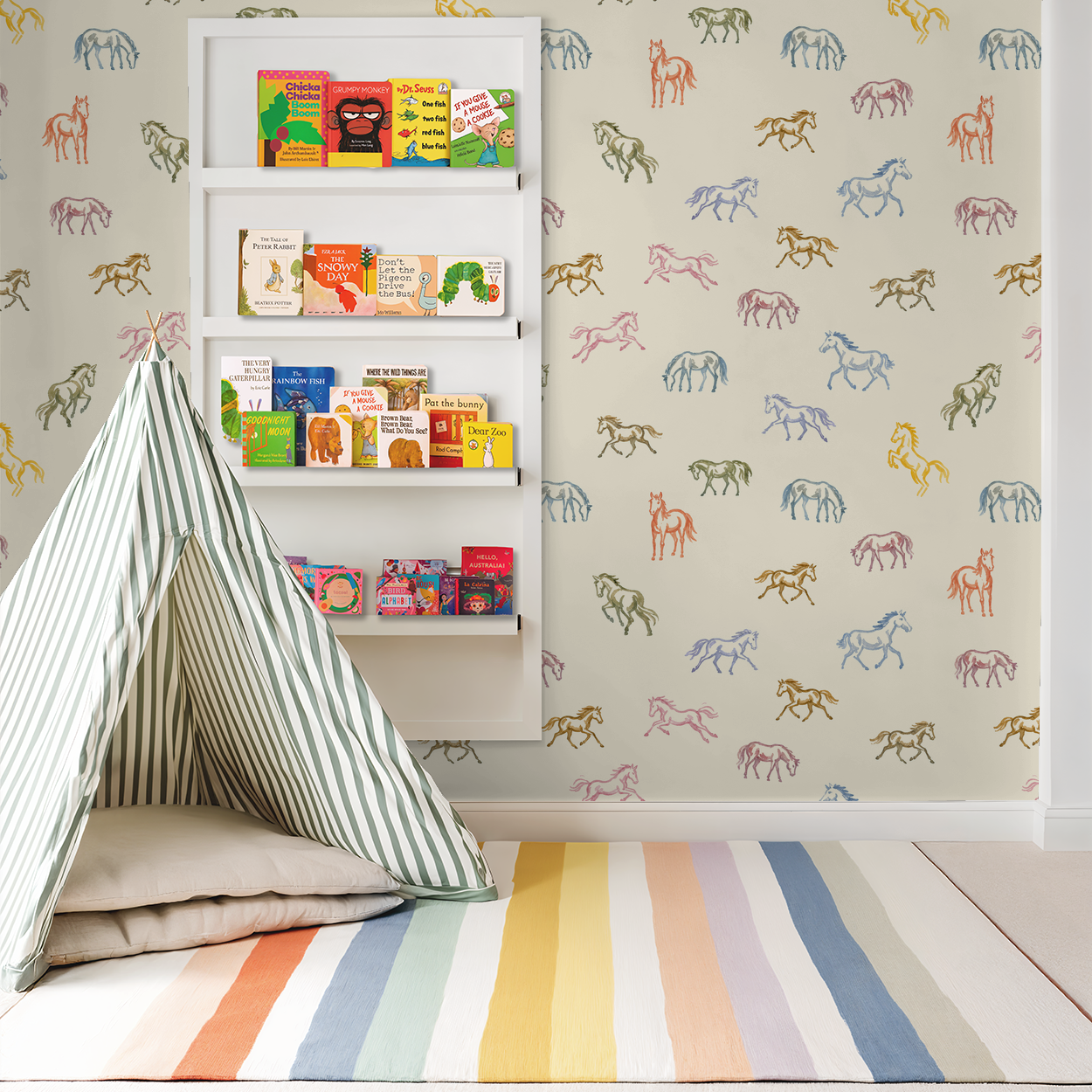 Whimsical pastel horse wallpaper in a child's playroom with books and striped tent.