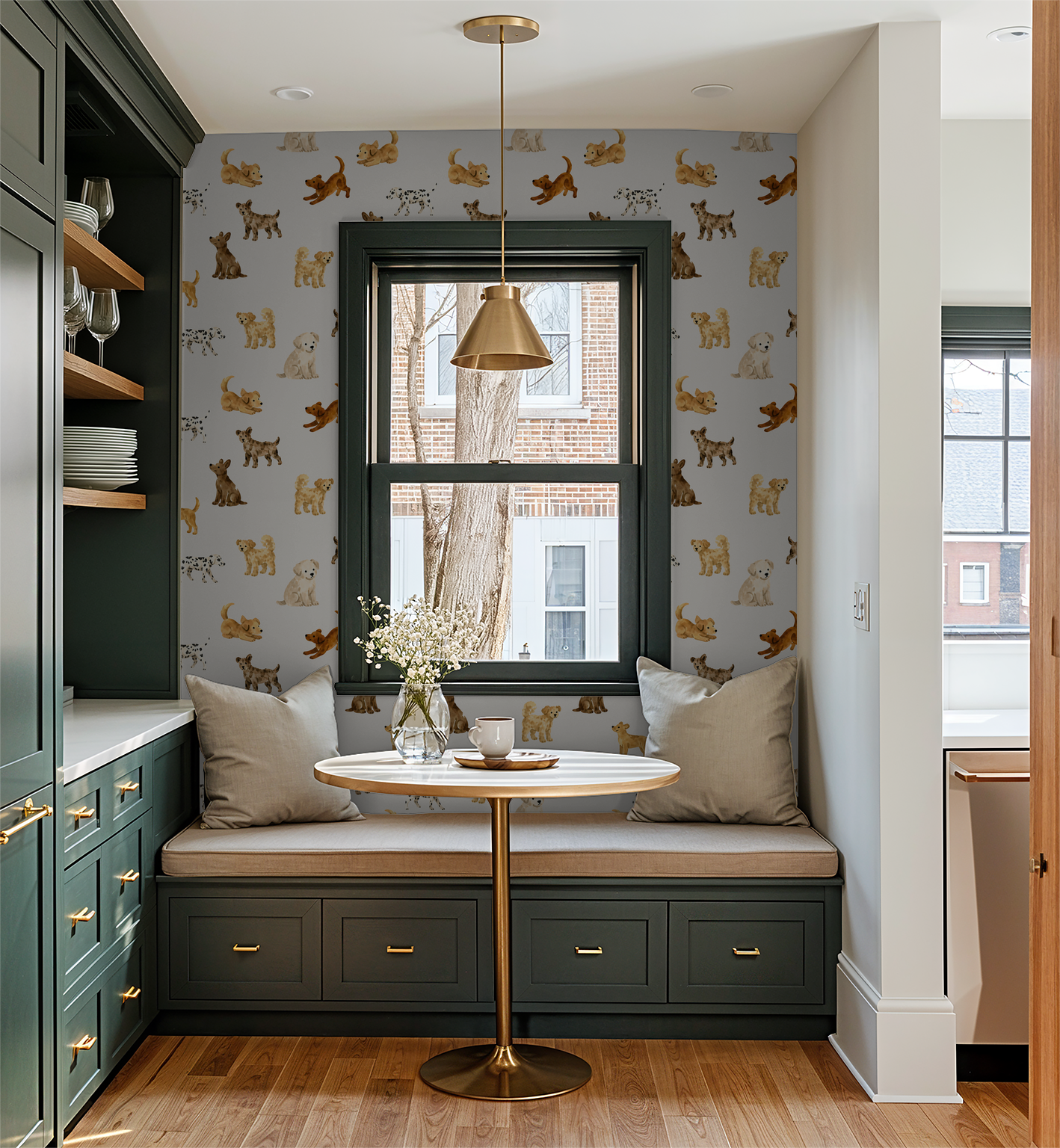 Playful dog wallpaper in cozy breakfast nook with green cabinets and gold accents.