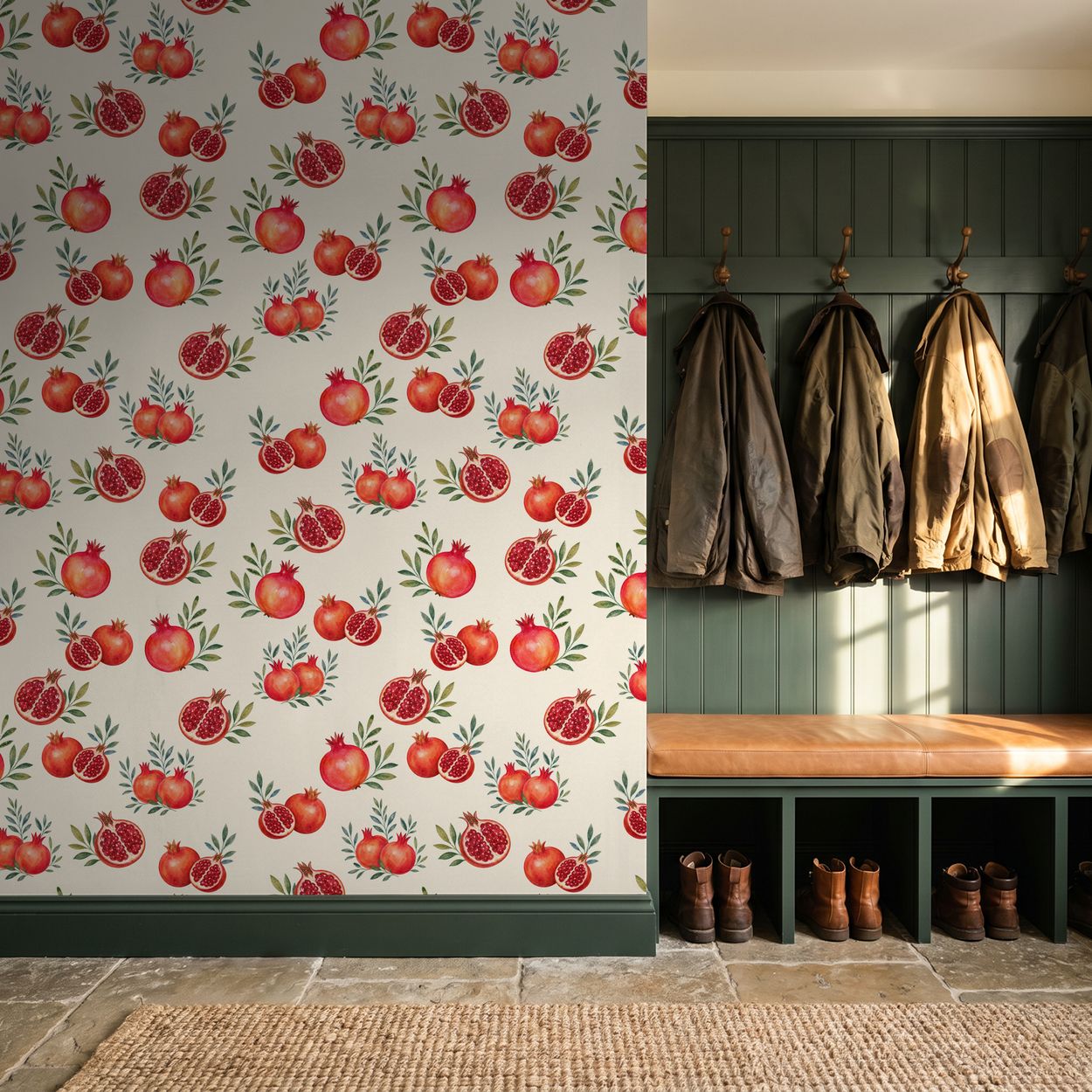 Pomegranate wallpaper with green leaves in entryway with coats and boots.