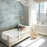 "Kinsbeth Wallpaper by Wall Blush enhancing a serene nursery with a floral accent wall."