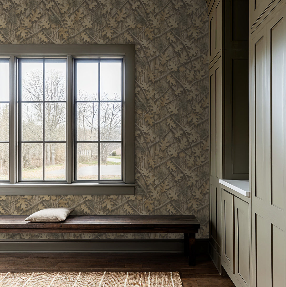 Rustic oak leaf and pine needle wallpaper in cozy entryway with bench.