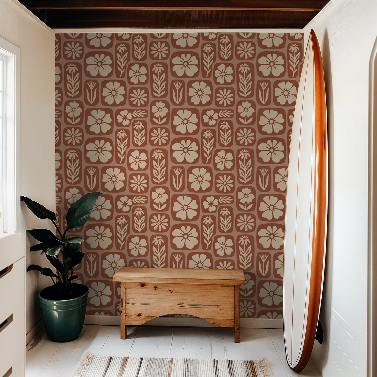 Rustic terracotta floral wallpaper in cozy room with wood bench and plant.