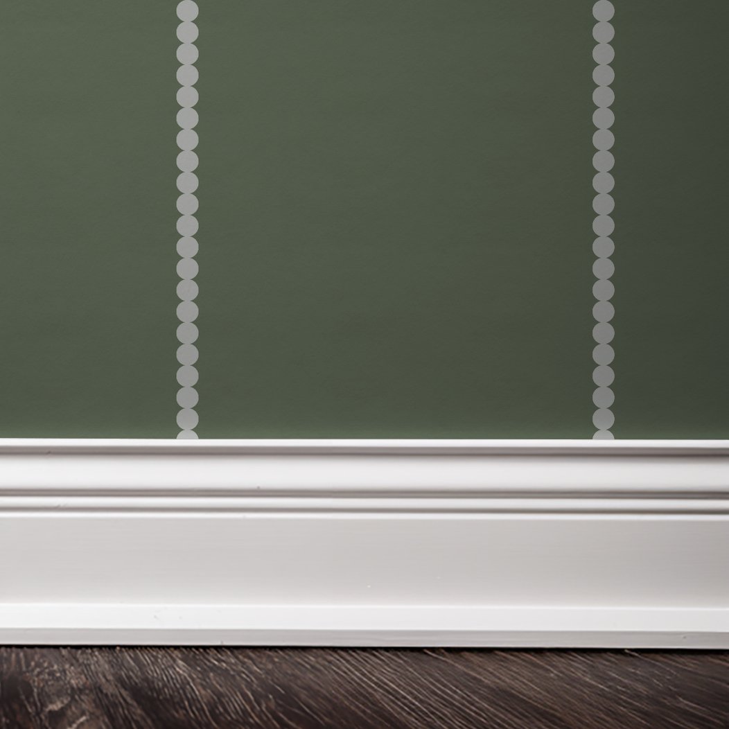 Sage green wallpaper with white dot stripes in a modern room setting.