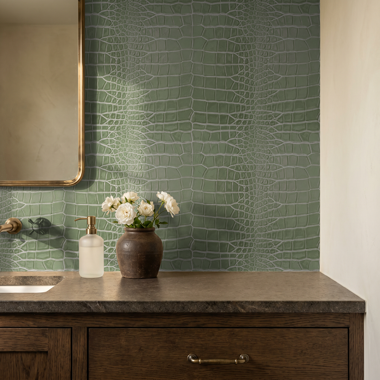 Sage green reptilian textured wallpaper in a bathroom with wooden vanity and flowers.