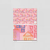 "Wall Blush Dream House Wallpaper sample with pink and playful house patterns for a nursery room."