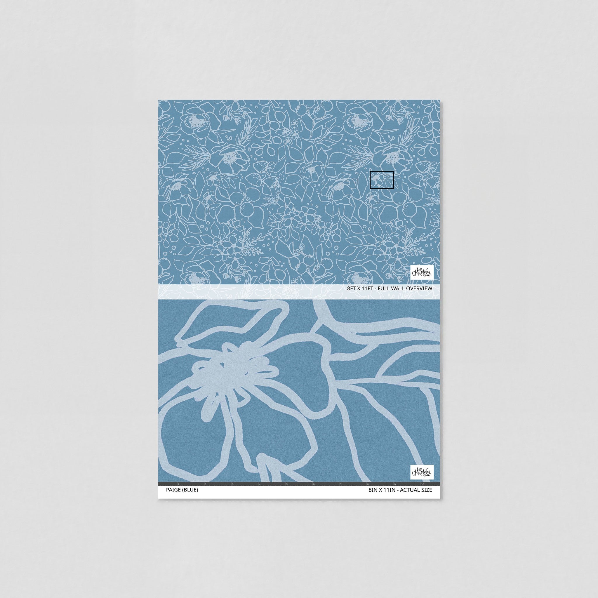 "Wall Blush brand Paige (Blue) Wallpaper sample, detailed floral design for modern home interiors."

Note: The provided image does not actually show the wallpaper applied to a room, but rather a sample piece of the wallpaper on a plain background. The alt text assumes the wallpaper would be intended for modern home interiors based on the design, as the type of room is not depicted in the image.