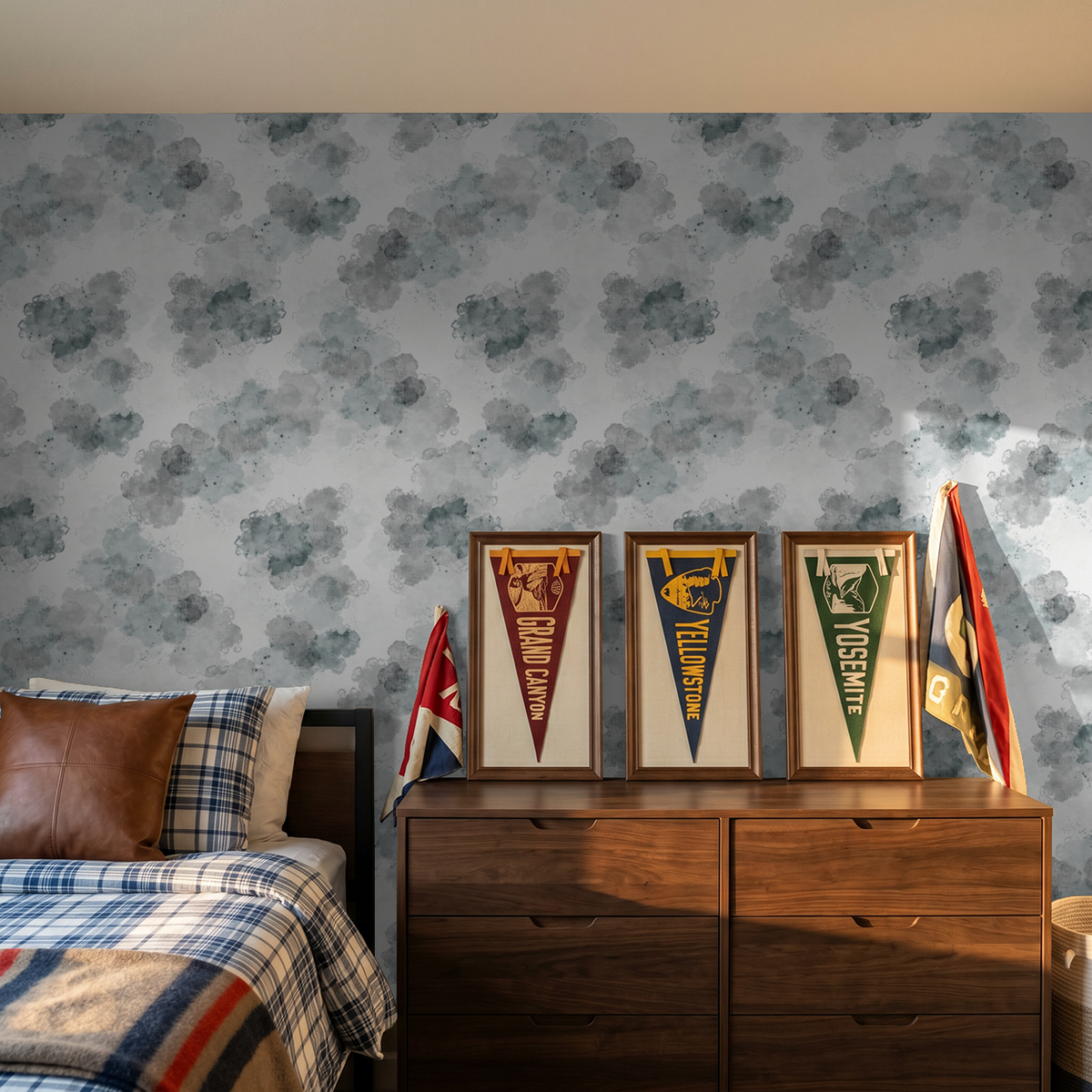 Slate gray cloud pattern wallpaper in a cozy bedroom with wooden dresser and flags.