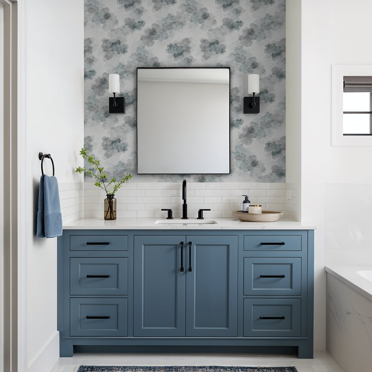 Slate gray cloud pattern wallpaper in modern bathroom with blue vanity.
