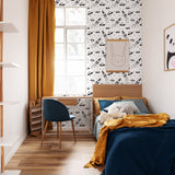 "Wall Blush Cosmo Wallpaper in stylish modern children's bedroom, with vibrant accent decor and cozy bedding."