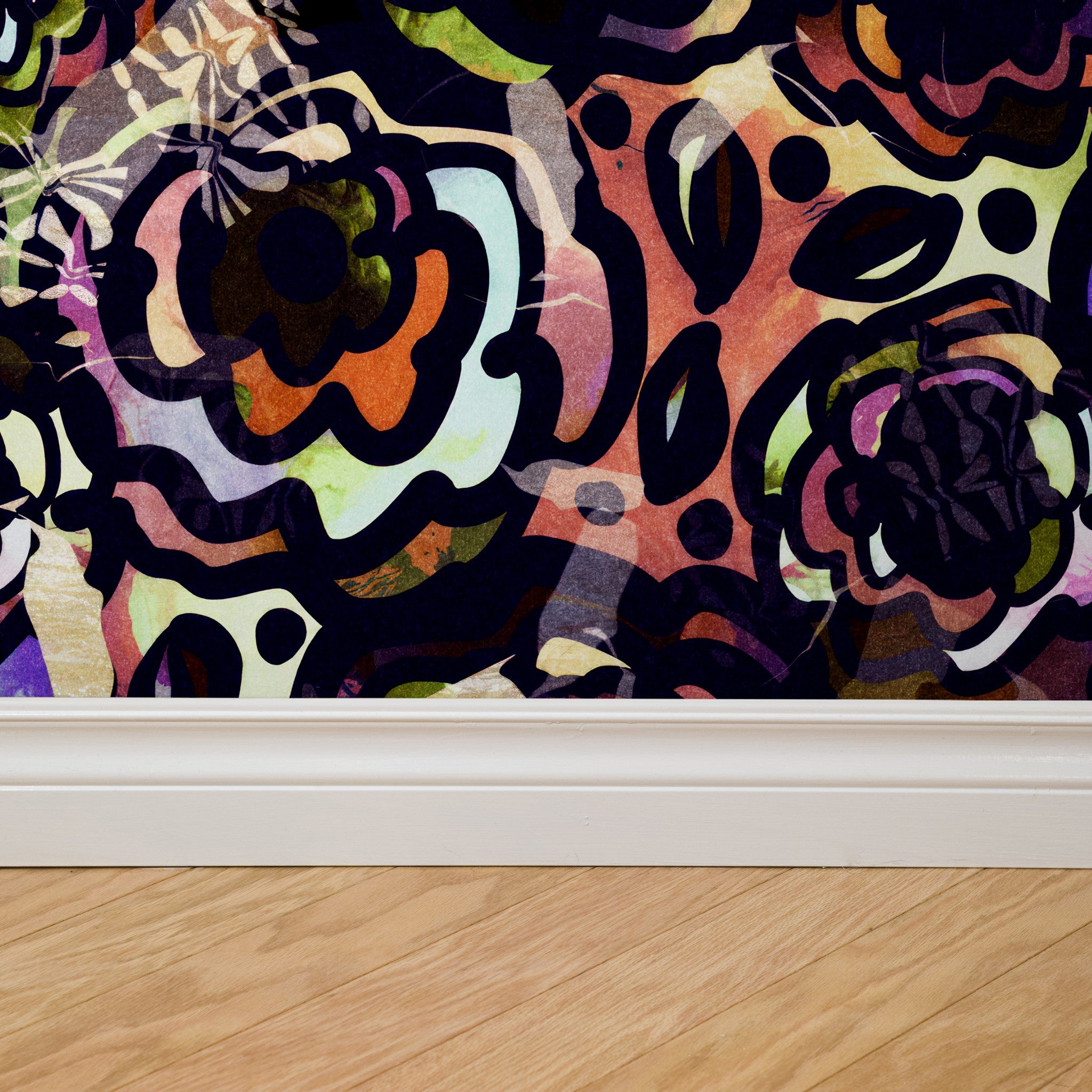 "Gypsy Wallpaper by Wall Blush featuring colorful floral design in a modern living room setting, wooden floor accent."