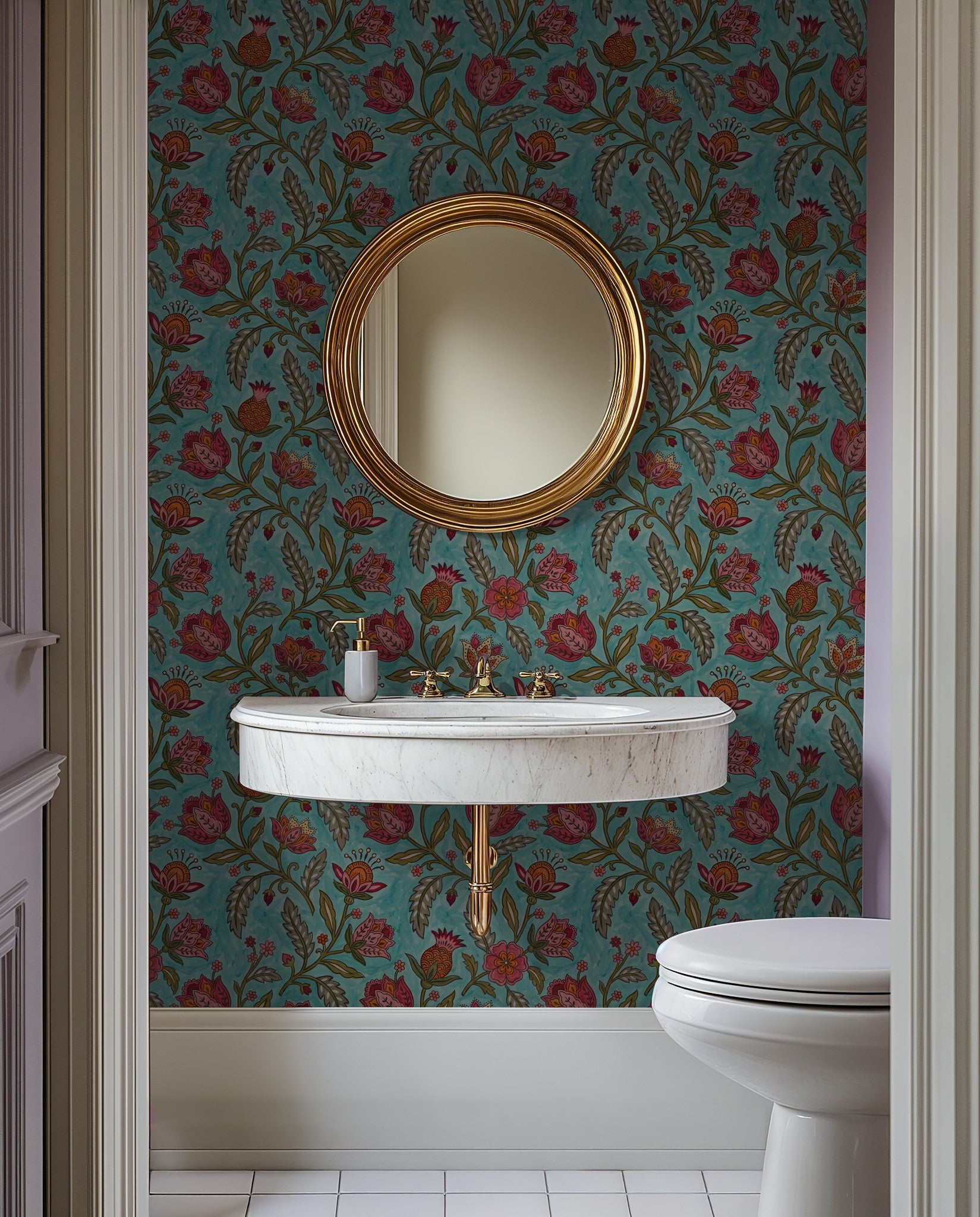 Teal floral wallpaper with red and orange motifs in a bathroom setting featuring a round mirror and marble sink.