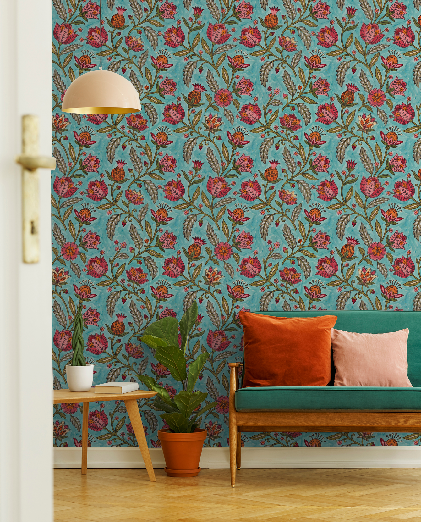 Teal floral wallpaper with red and orange flowers in a bohemian living room setting.