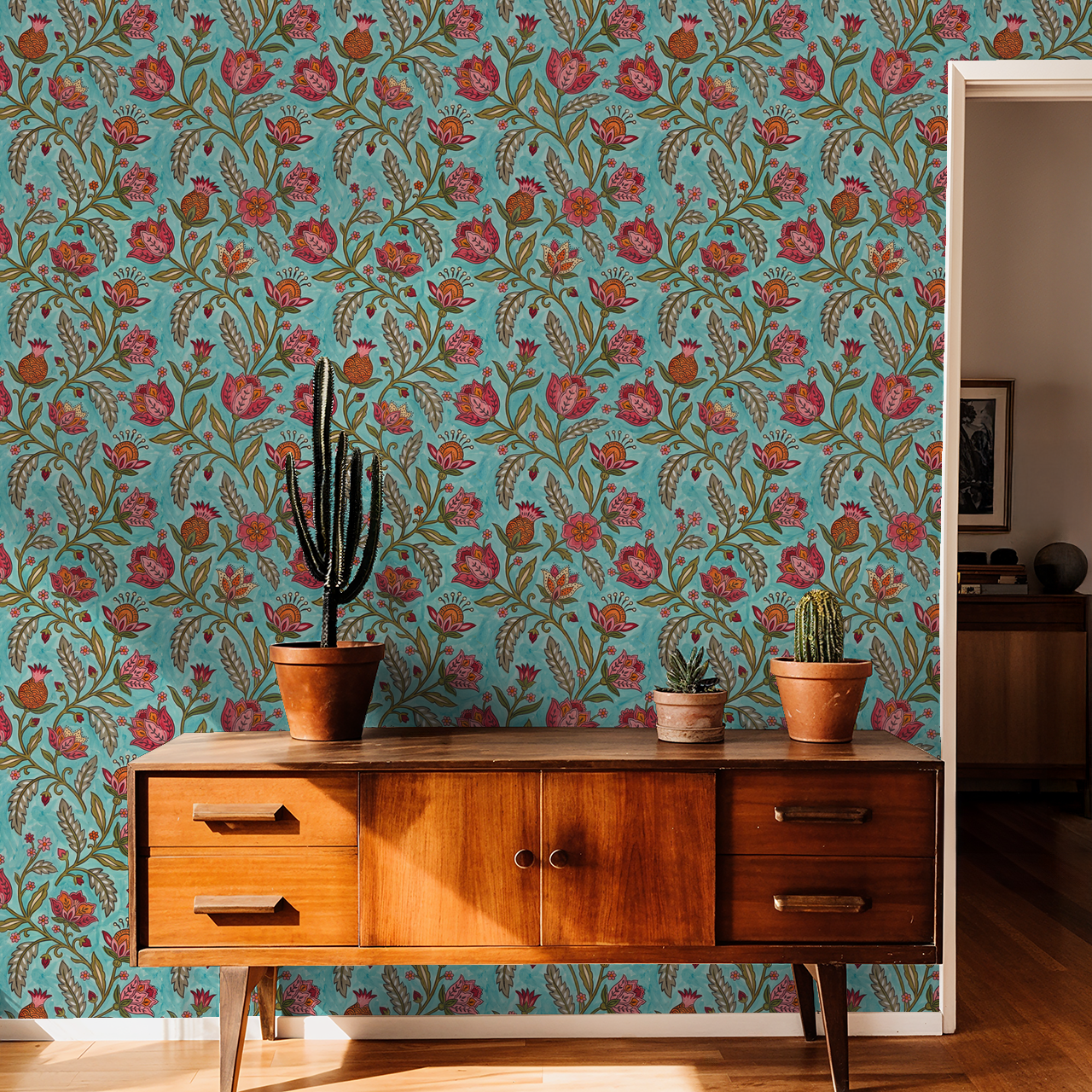 Teal floral wallpaper with red and orange flowers in a vintage room setting.