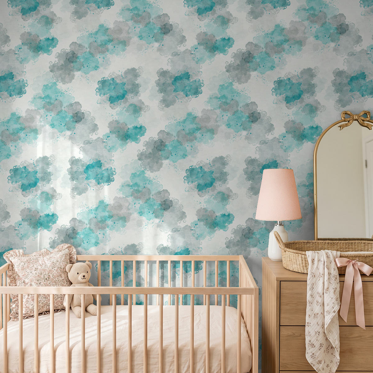 Teal and gray watercolor cloud wallpaper in a serene nursery setting.