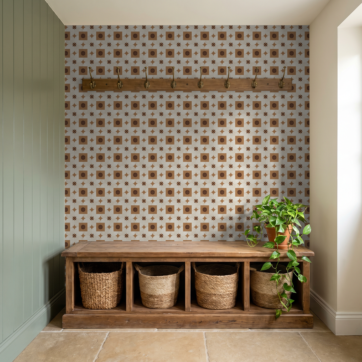 Terracotta and cream geometric wallpaper in entryway with wooden bench and baskets.