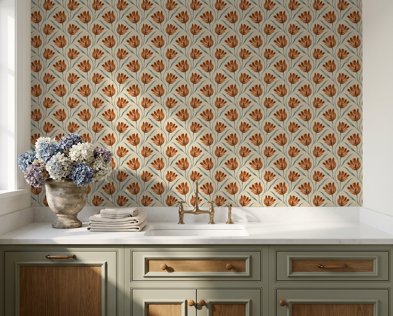 Terracotta floral wallpaper in kitchen with cream and green cabinetry.