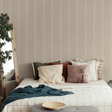 "Little Haven Wallpaper by Wall Blush in cozy bedroom, neutral stripes enhancing room decor and focus on quality."