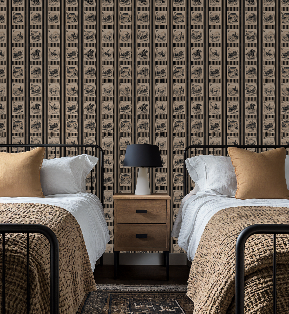 Vintage Wild West stamp wallpaper in cozy bedroom with twin beds.