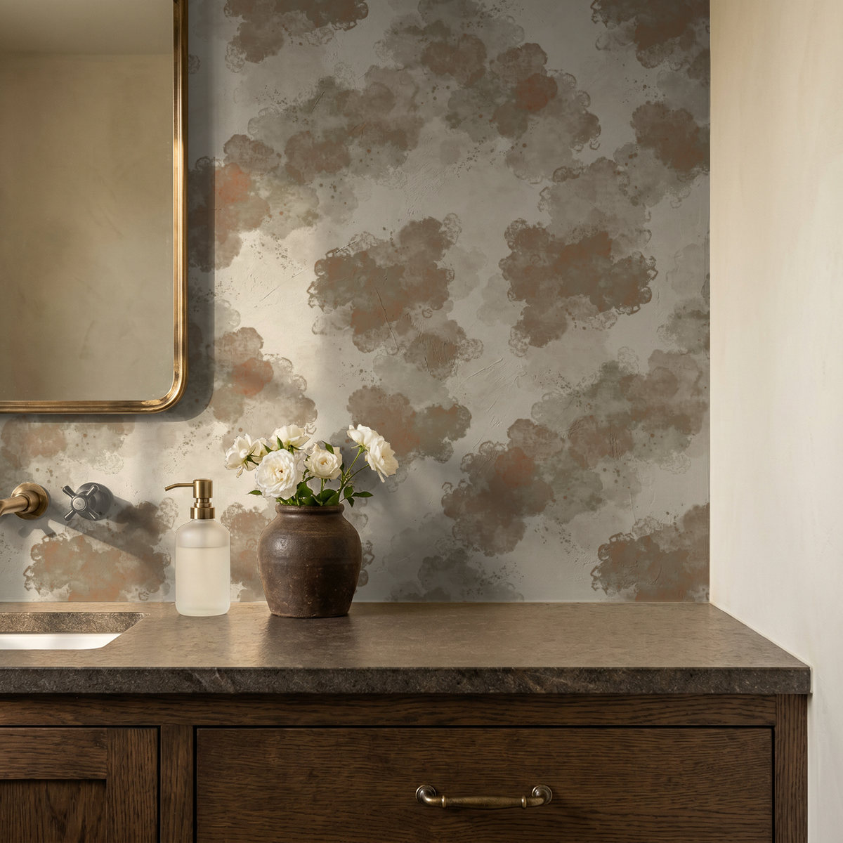Warm taupe abstract watercolor wallpaper in bathroom with wooden vanity and flowers.