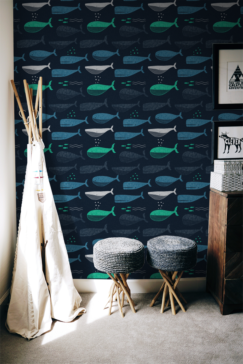 Navy wallpaper with teal and white whale pattern in cozy room setting.