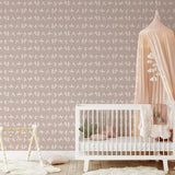 "Wall Blush's Keen & Clever Wallpaper featured in a stylish, modern nursery room, enhancing the room's cozy ambiance."