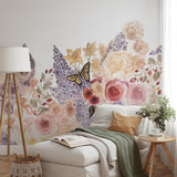 "Garden Whimsy Wallpaper by Wall Blush, floral design in cozy living room setting with sofa and decor."