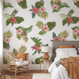 "Tropical Mahalo Wallpaper by Wall Blush in cozy bedroom setting, showcasing vibrant floral patterns."