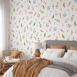 "Wall Blush's Bliss Wallpaper enhancing a cozy bedroom's decor with its vibrant floral pattern, focusing on the elegant design."