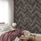 "Wall Blush's Country Roads Wallpaper featured in a cozy bedroom setting, with a stylish herringbone pattern."
