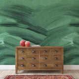 "Wall Blush Emerald Wallpaper featured in stylish living room with wooden dresser and decor accents."